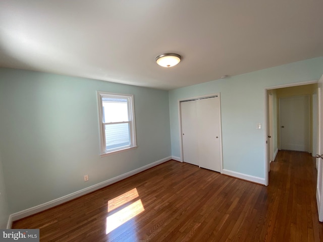 spare room with dark hardwood / wood-style flooring