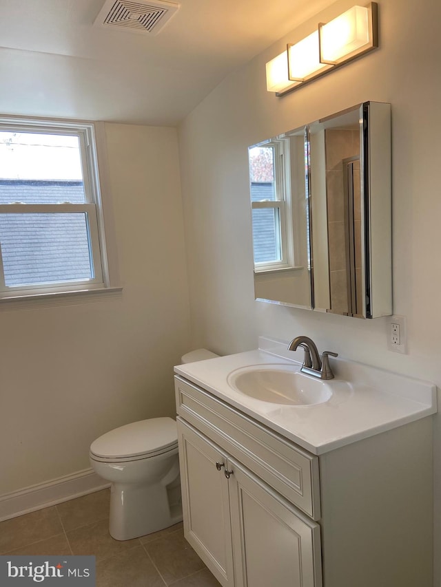 bathroom with tile floors, toilet, and vanity