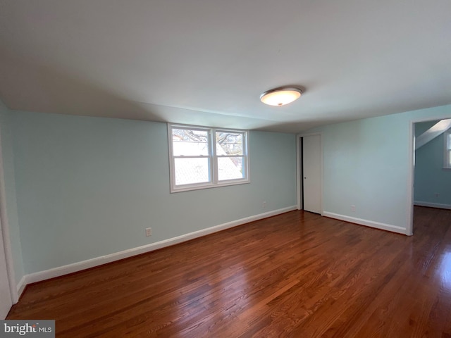 empty room with dark hardwood / wood-style flooring