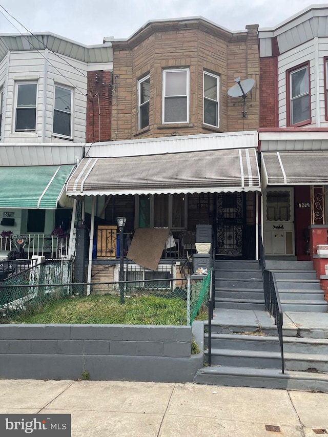 view of property featuring covered porch