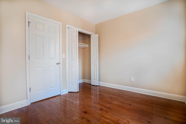 unfurnished bedroom with dark hardwood / wood-style floors