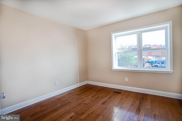 spare room featuring dark hardwood / wood-style flooring