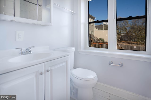 bathroom with tile floors, toilet, and vanity