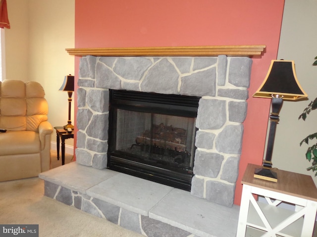 details featuring a stone fireplace and carpet floors