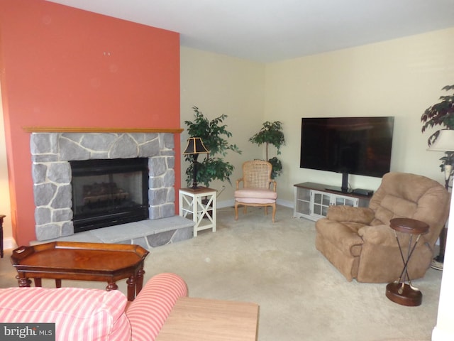 carpeted living room featuring a fireplace