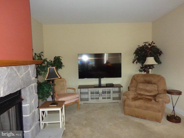 carpeted living room with a fireplace