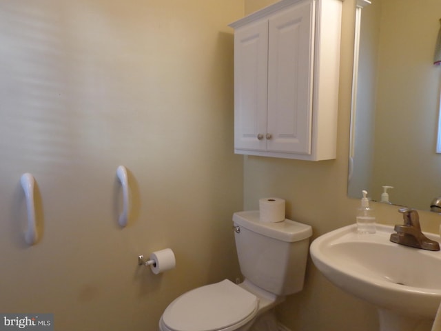 bathroom with toilet and sink