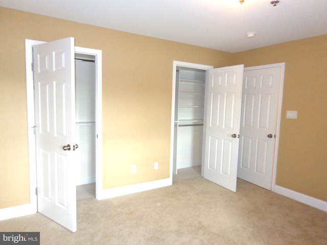 unfurnished bedroom featuring light colored carpet