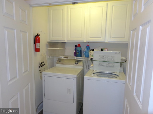 laundry area with cabinets and washing machine and clothes dryer