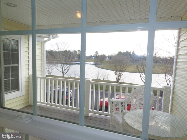 unfurnished sunroom with a water view and a wealth of natural light