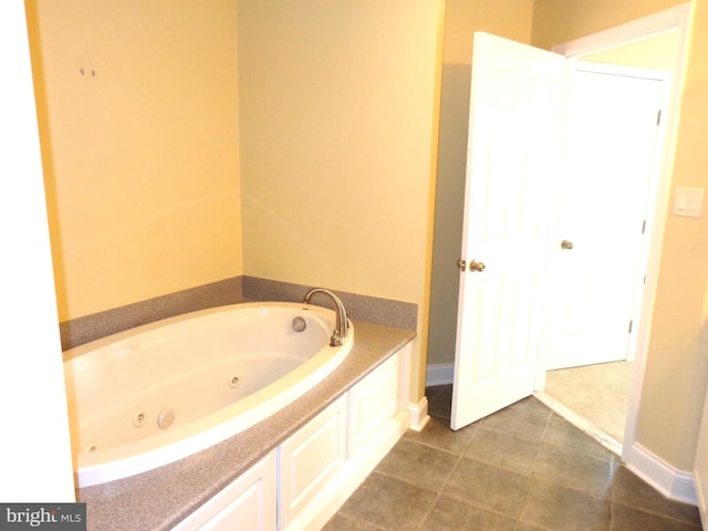 bathroom with a bath and tile flooring