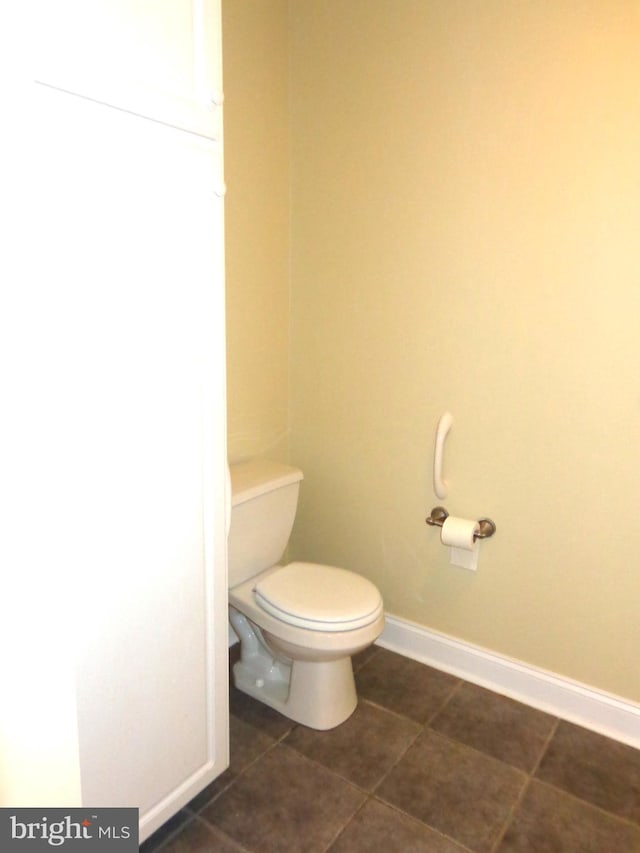 bathroom with tile flooring and toilet