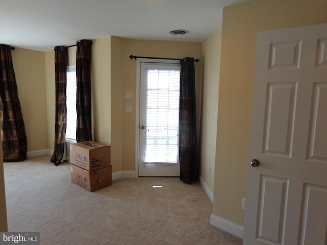 interior space featuring light colored carpet