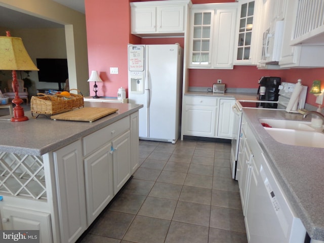 kitchen featuring white appliances, white cabinets, and tile flooring