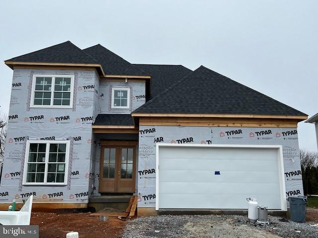 property in mid-construction with a garage