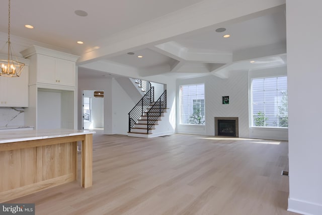 5824 Wild Lilac Dr, Lot East Petersburg, PA 17520 - unfurnished living room featuring light wood-type flooring, stairway, a fireplace, and a wealth of natural light