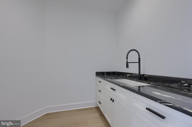 5824 Wild Lilac Dr, Lot East Petersburg, PA 17520 - kitchen with a sink, white cabinetry, light wood-type flooring, dark stone countertops, and baseboards