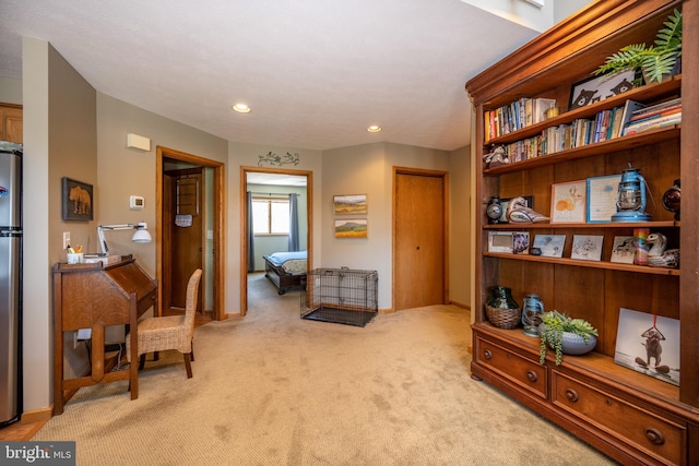 sitting room featuring light carpet