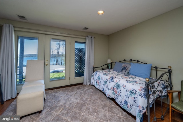 bedroom featuring french doors, light hardwood / wood-style flooring, and access to outside