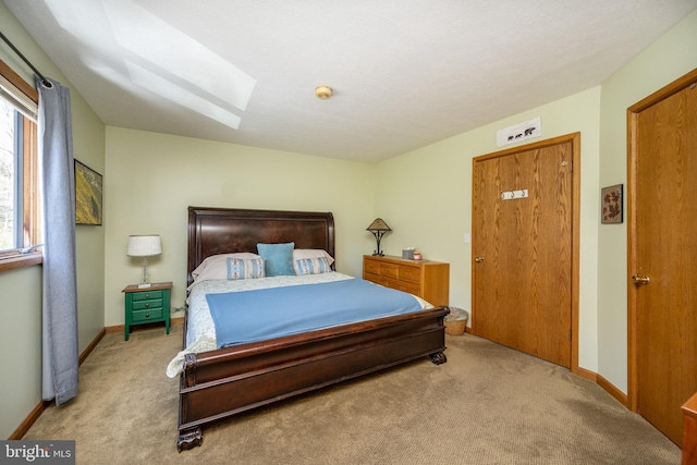 carpeted bedroom with a skylight