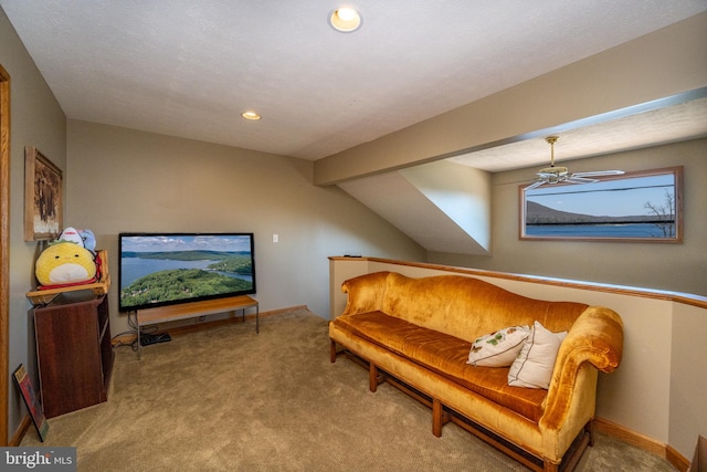 living area featuring carpet flooring, ceiling fan, a textured ceiling, and beamed ceiling