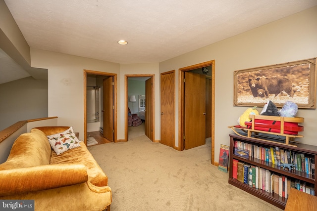 sitting room featuring light colored carpet