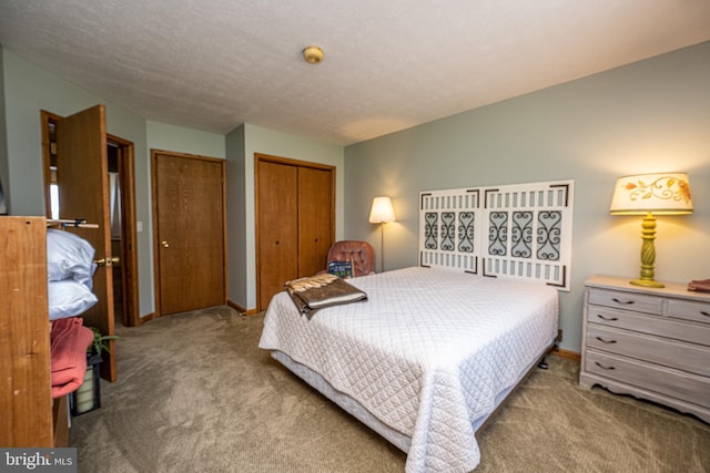 bedroom with a textured ceiling, light carpet, and a closet