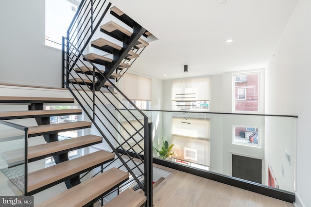 stairs with light hardwood / wood-style floors