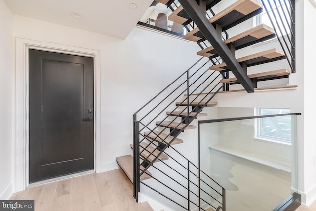 staircase with light hardwood / wood-style flooring