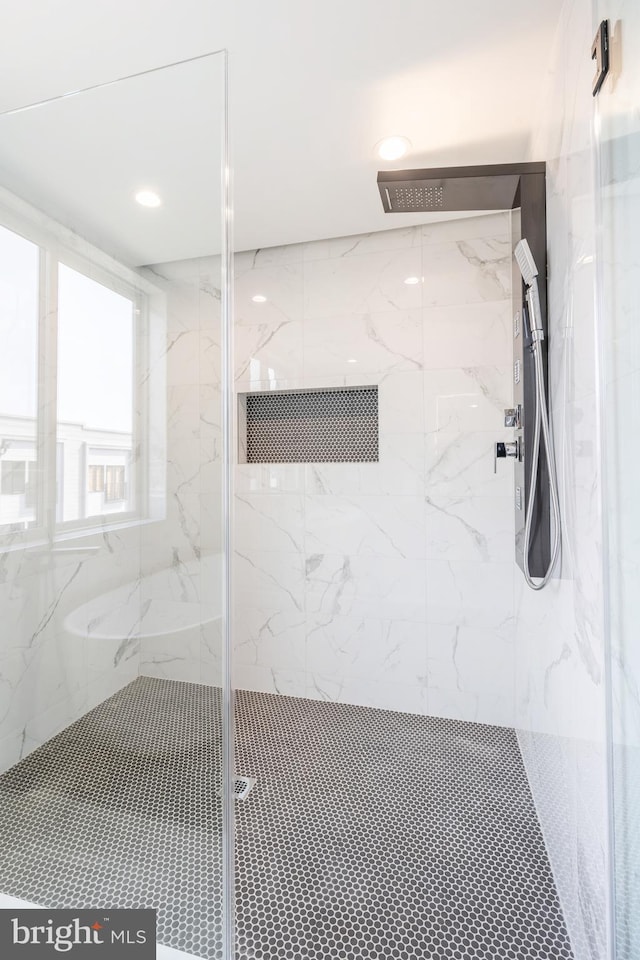 bathroom featuring a shower with door