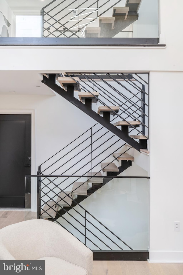 staircase featuring light wood-type flooring