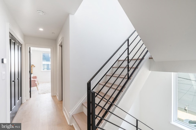 stairs with light hardwood / wood-style floors