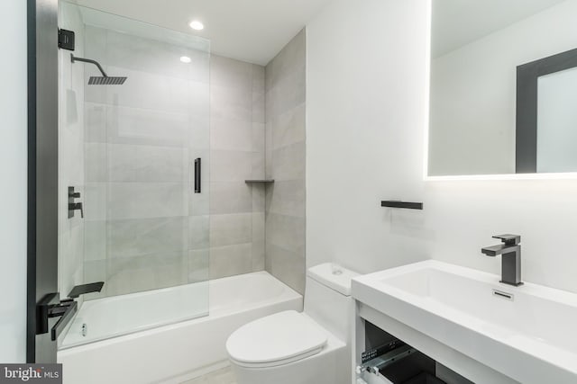 full bathroom featuring shower / bath combination with glass door, oversized vanity, and toilet