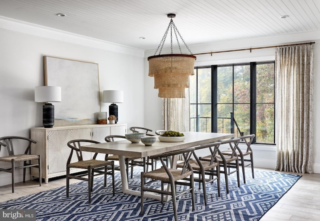 dining area featuring light wood-type flooring, a wealth of natural light, ornamental molding, and wooden ceiling