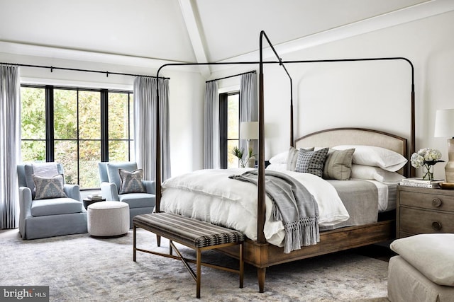 bedroom featuring lofted ceiling with beams and light colored carpet