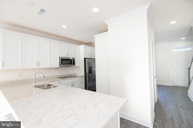 300 Dixon St Unit 202, Easton, MD 21601 - kitchen with stainless steel appliances, wood finished floors, white cabinetry, a peninsula, and light stone counters