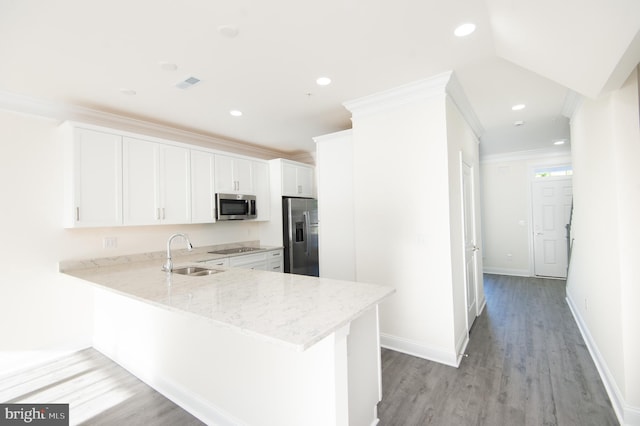 300 Dixon St Unit 202, Easton, MD 21601 - kitchen with stainless steel appliances, light stone countertops, light wood-style floors, a peninsula, and white cabinets
