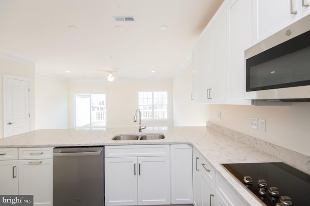 300 Dixon St Unit 202, Easton, MD 21601 - kitchen with stainless steel appliances, crown molding, a peninsula, and white cabinetry