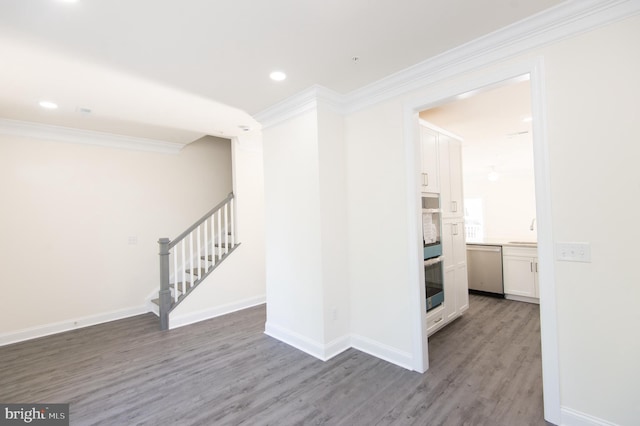 300 Dixon St Unit 202, Easton, MD 21601 - spare room featuring crown molding, wood finished floors, stairway, and recessed lighting