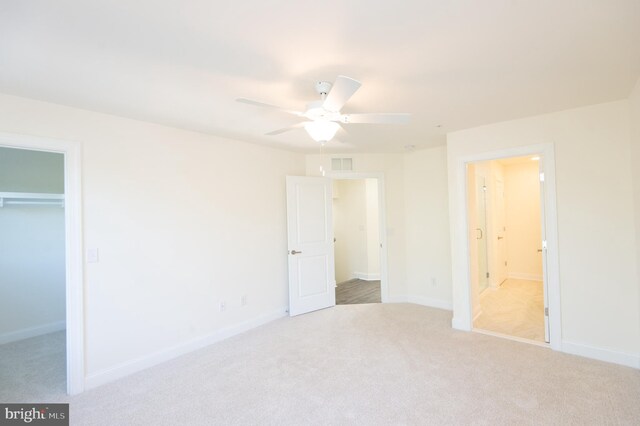 300 Dixon St Unit 202, Easton, MD 21601 - unfurnished bedroom with carpet floors, a walk in closet, a closet, connected bathroom, and ceiling fan