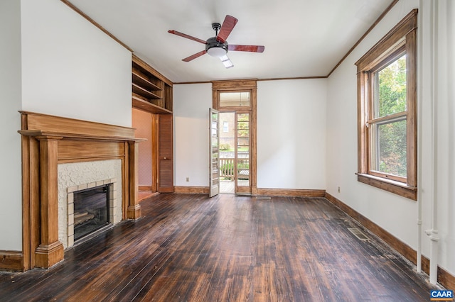 unfurnished living room featuring ornamental molding, ceiling fan, plenty of natural light, and dark wood-type flooring