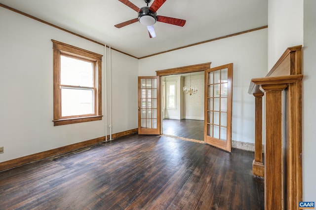 empty room with ceiling fan with notable chandelier, dark hardwood / wood-style floors, french doors, and crown molding