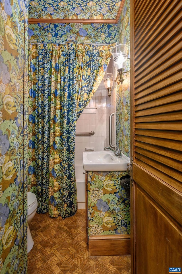 bathroom featuring vanity, parquet flooring, and toilet