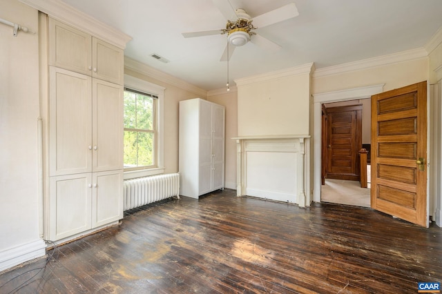 unfurnished bedroom featuring dark hardwood / wood-style flooring, a closet, radiator, ceiling fan, and ornamental molding