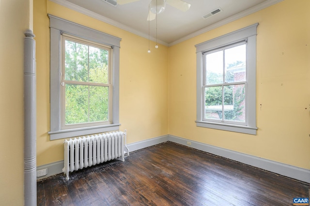 empty room with ornamental molding, radiator, ceiling fan, and dark hardwood / wood-style floors