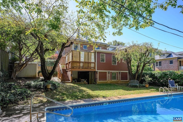 exterior space featuring a fenced in pool and a yard