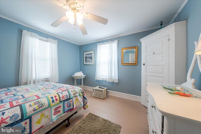 bedroom featuring multiple windows, ceiling fan, crown molding, and light wood-type flooring