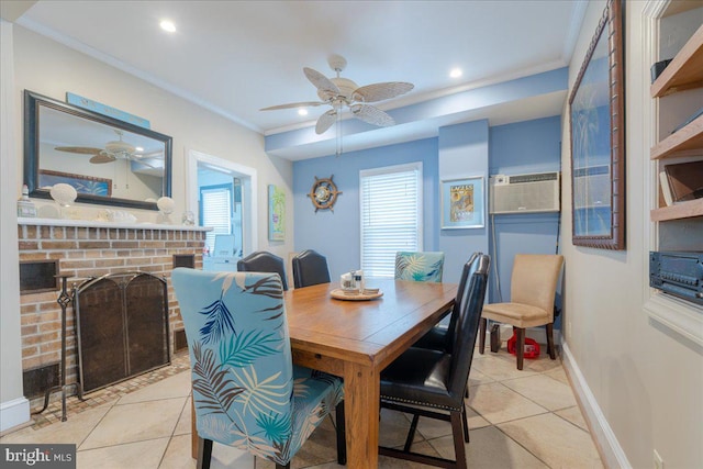 tiled dining area with ceiling fan, ornamental molding, and a fireplace