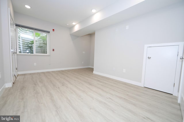 empty room with light hardwood / wood-style flooring