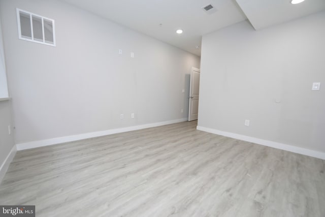 spare room featuring light hardwood / wood-style flooring